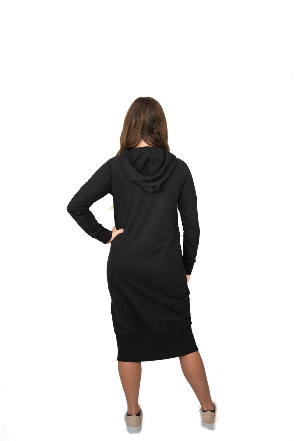 Woman wearing a black hooded dress from Snoga Athletics, back view on white background