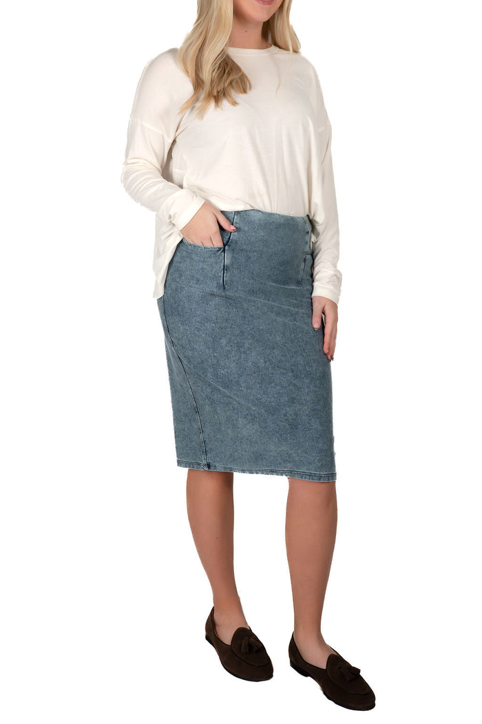 Woman wearing a long sleeve top and modest denim skirt from Snoga Athletics