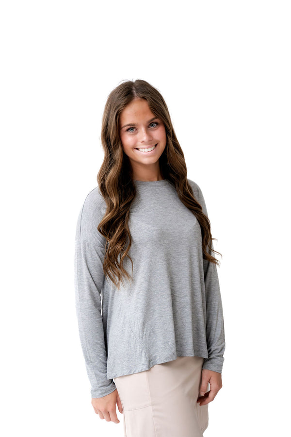 Woman modeling Snoga Athletics gray long sleeve modest activewear top and beige skirt
