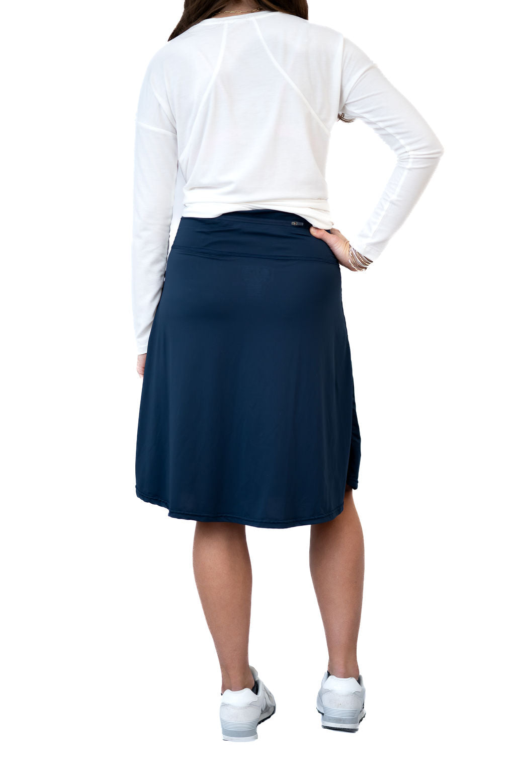 Woman wearing Snoga Athletics navy modest activewear skirt and white long sleeve top