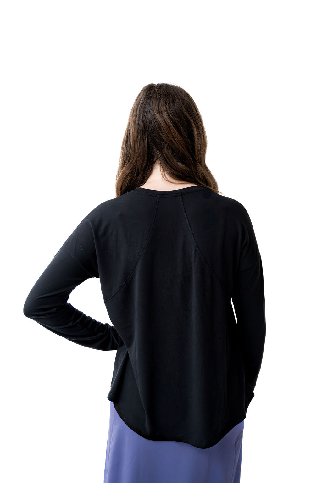 Woman in black long sleeve top and purple skirt, modest activewear by Snoga Athletics, back view