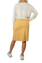Snoga Athletics yellow modest activewear skirt with white long-sleeve top, back view