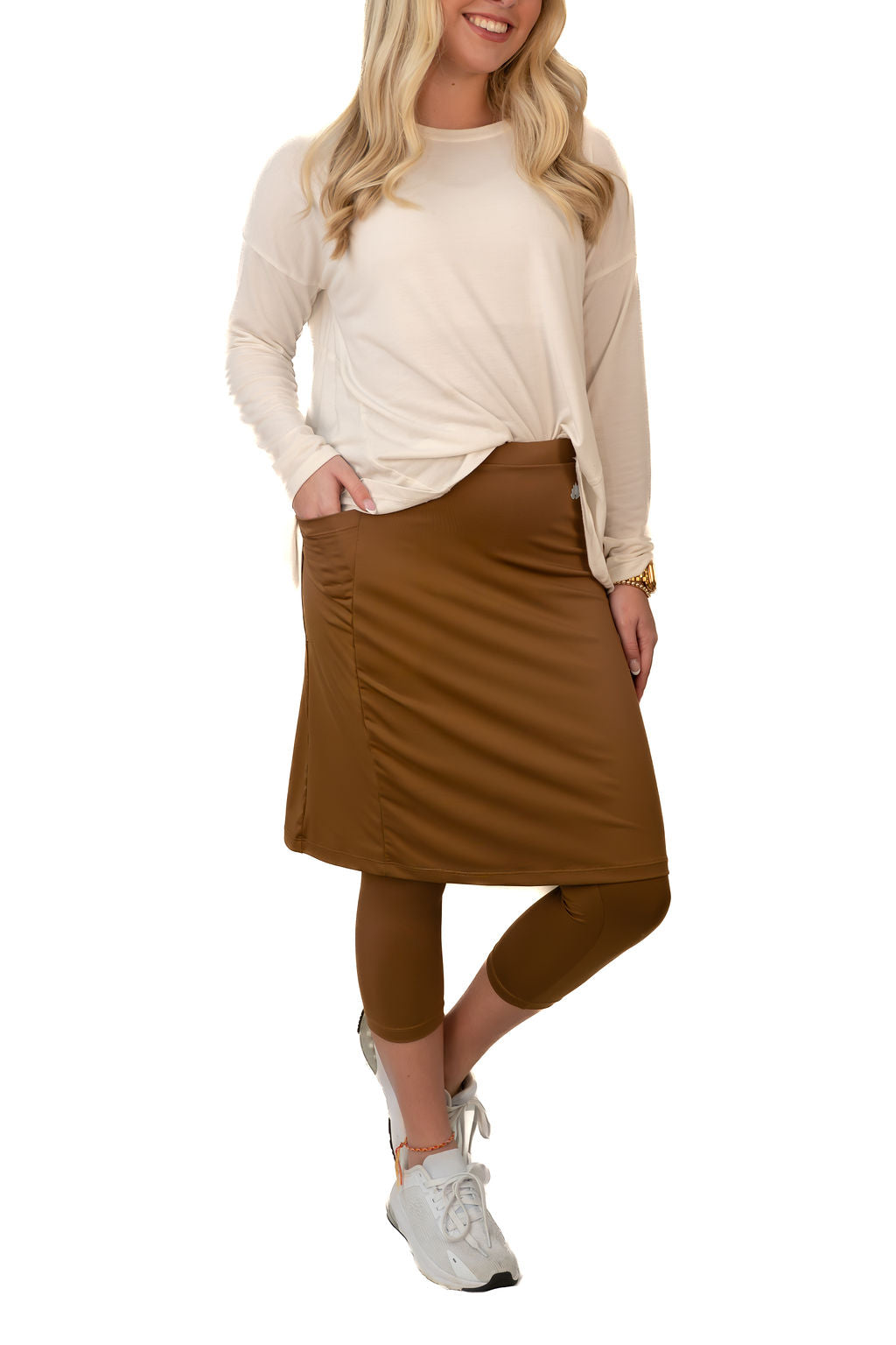 Woman wearing Snoga Athletics brown modest skirt leggings and ivory long sleeve shirt