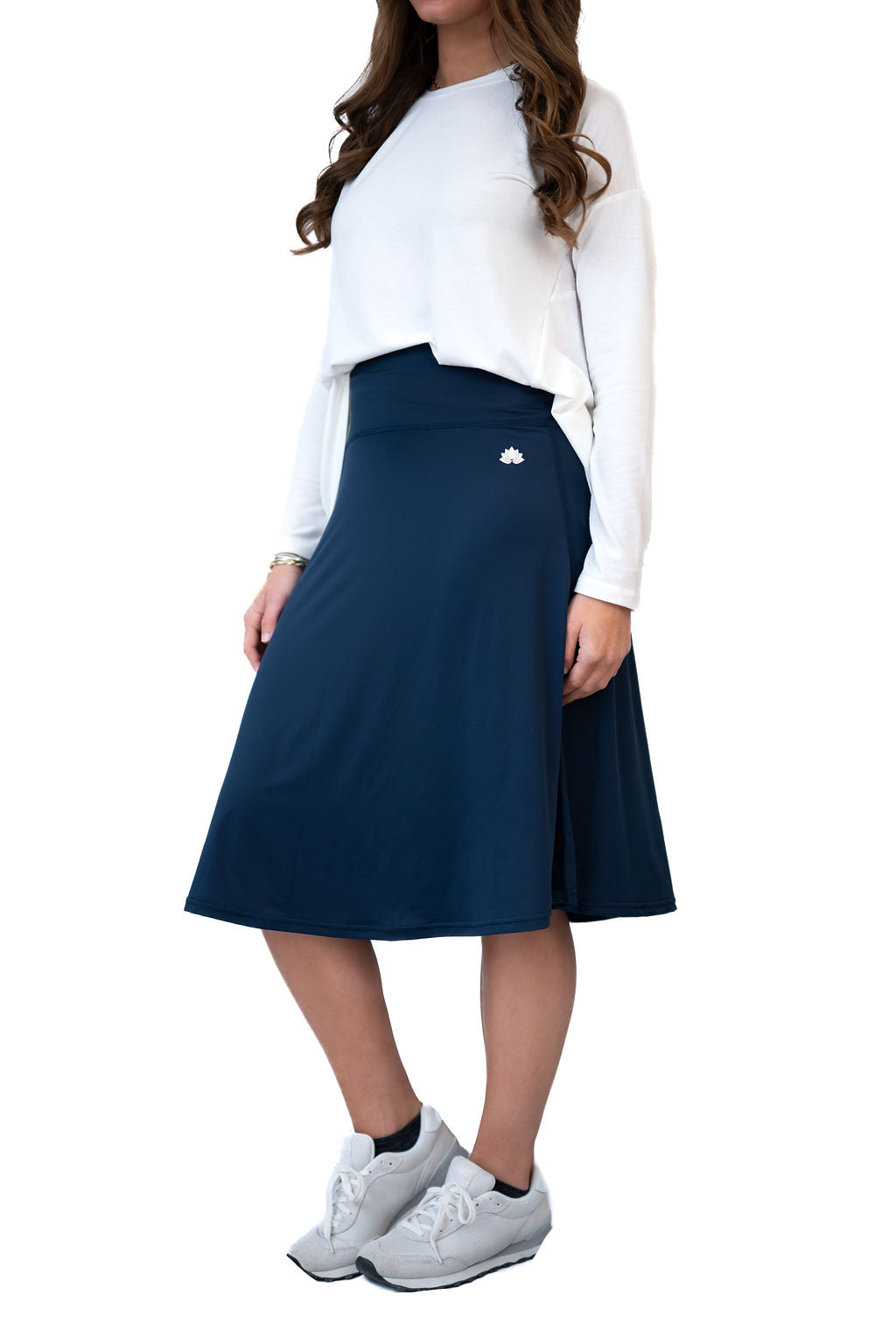 Woman wearing Snoga Athletics navy modest activewear skirt and white top