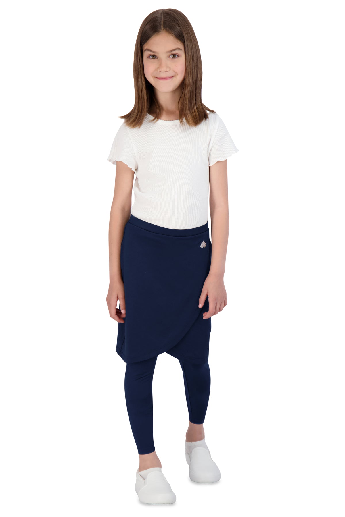 Girl in Snoga Athletics navy modest skirt leggings and white shirt, studio background