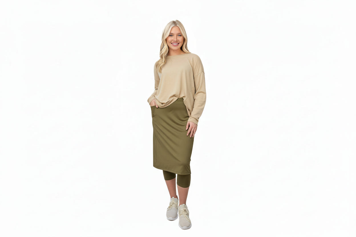 Woman wearing Snoga Athletics modest olive skirt with beige long sleeve top and leggings