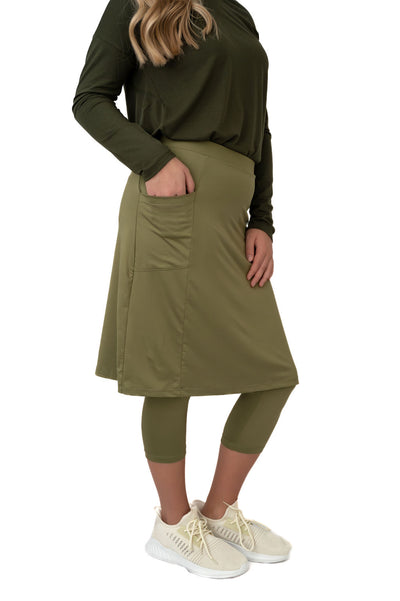 Snoga Athletics olive green modest skirt leggings with pocket, long sleeve top, and sneakers