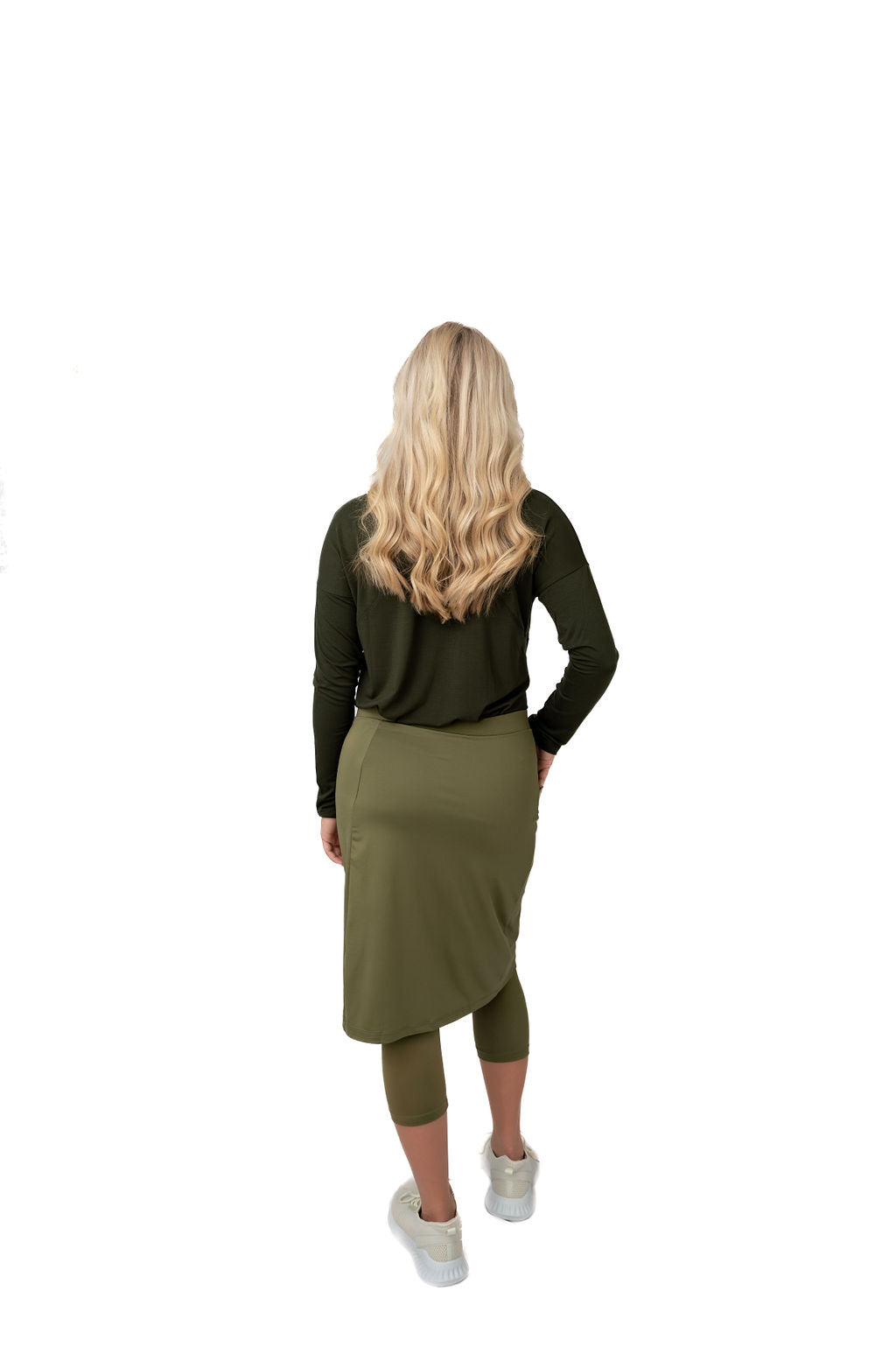 Woman modeling Snoga Athletics olive modest skirt leggings activewear, back view