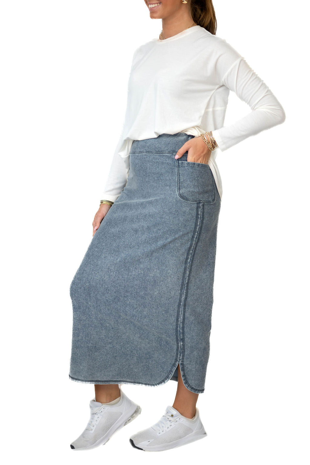 Snoga Athletics model in modest denim ankle-length skirt, white long sleeve top, and sneakers