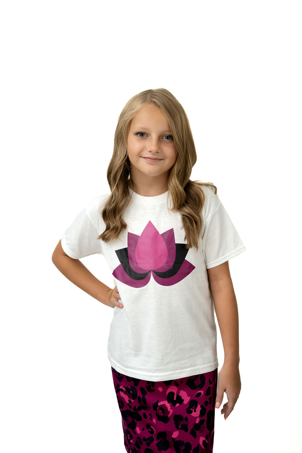 Girl modeling Snoga Athletics white lotus graphic tee and pink leopard skirt, modest activewear