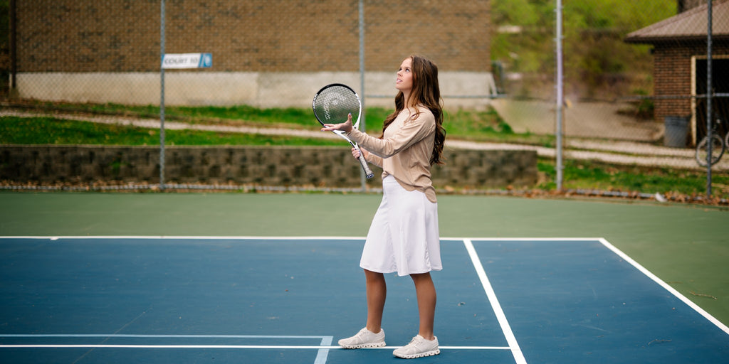 Young woman in a white snoga playing tennis