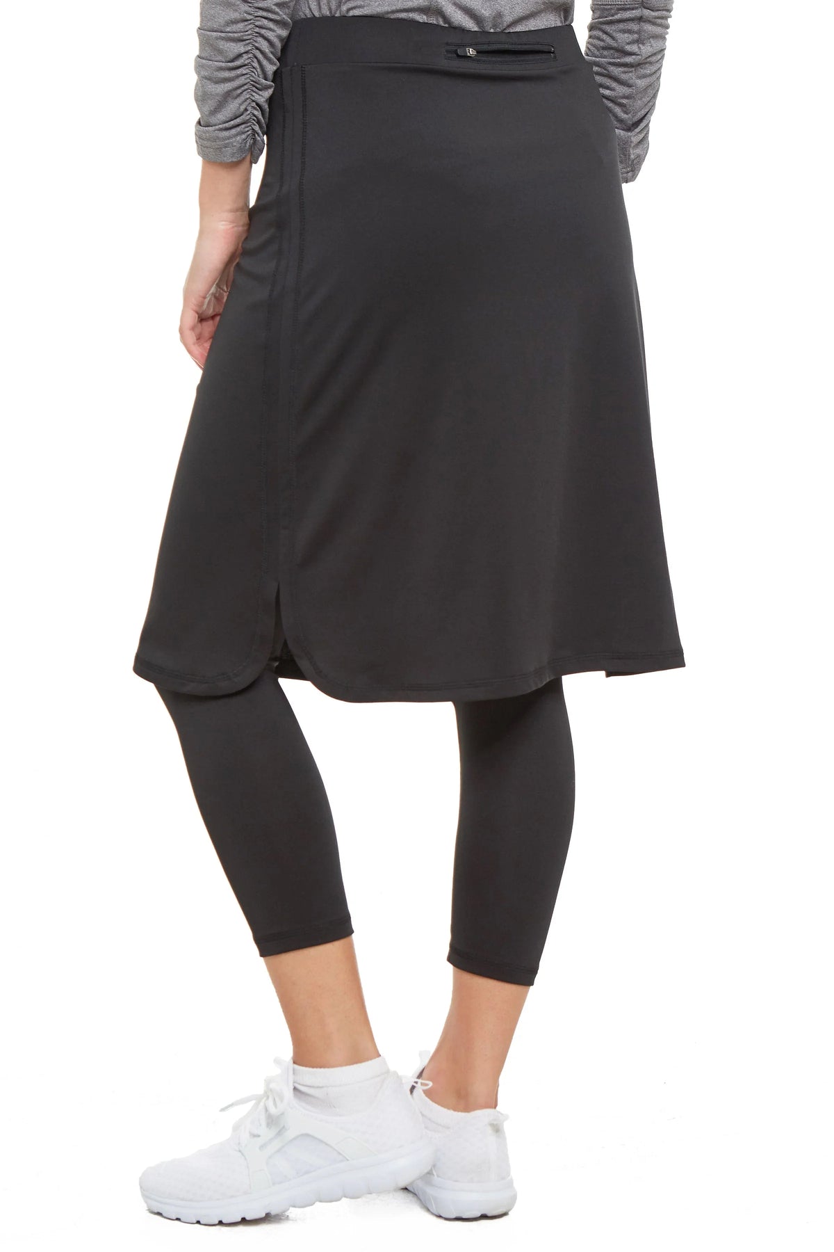 Woman wearing black 3/4 length skirted leggings, cropped shirttail style by Snoga Athletics