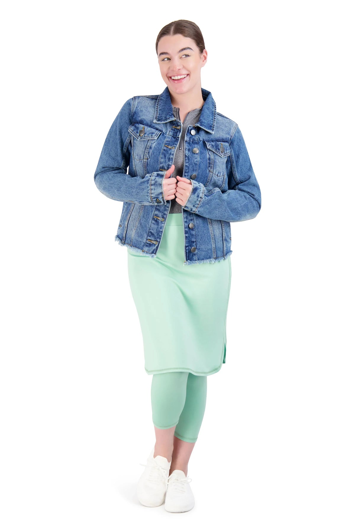 Woman wearing Snoga Athletics denim jacket over modest mint skirt and leggings