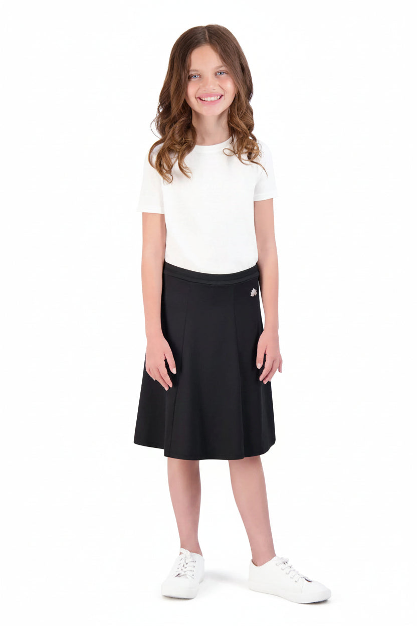 Girl wearing Snoga Athletics black ballet skirt with attached leggings and white shirt