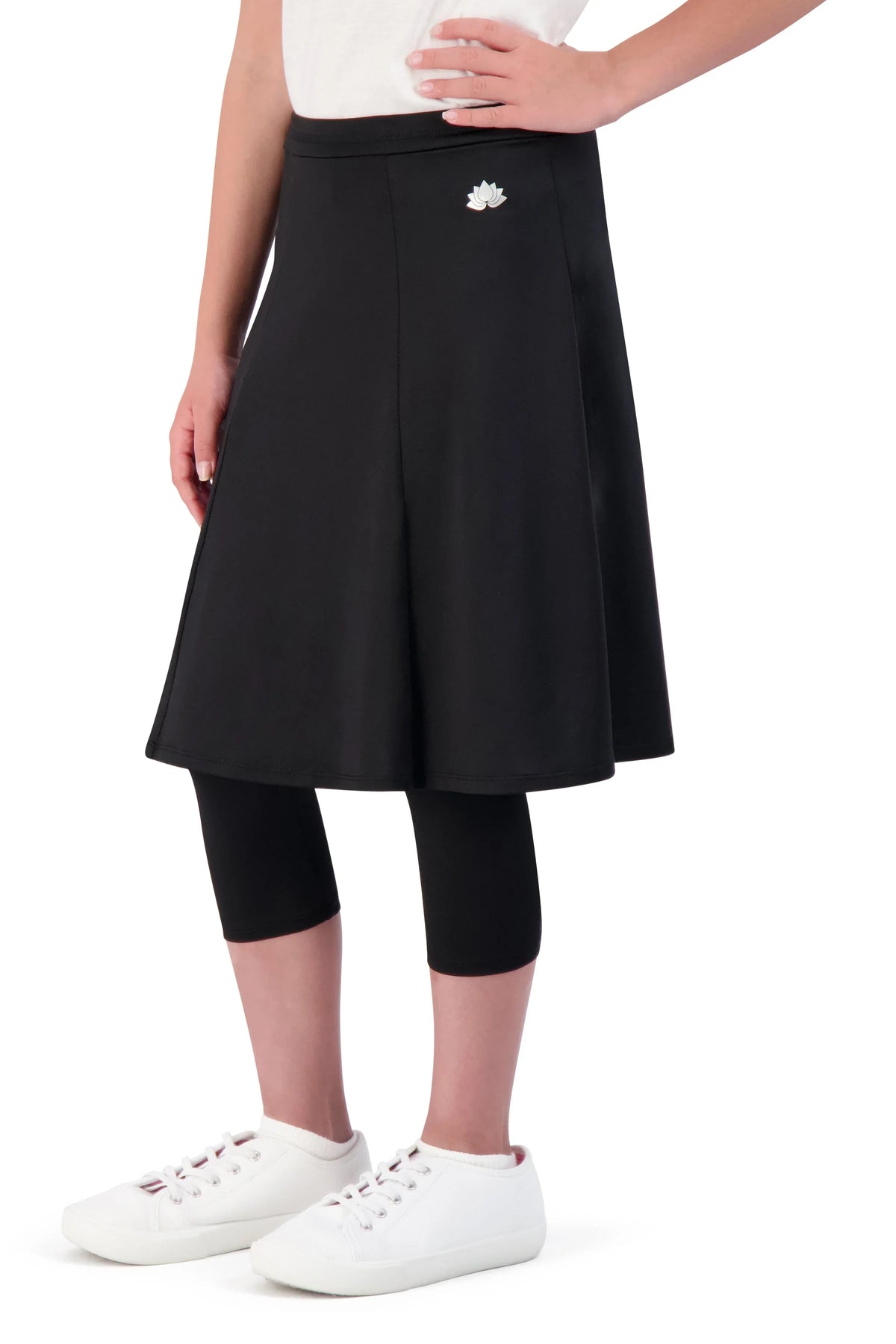 Girl wearing Snoga Athletics black ballet skirt with attached leggings and white sneakers