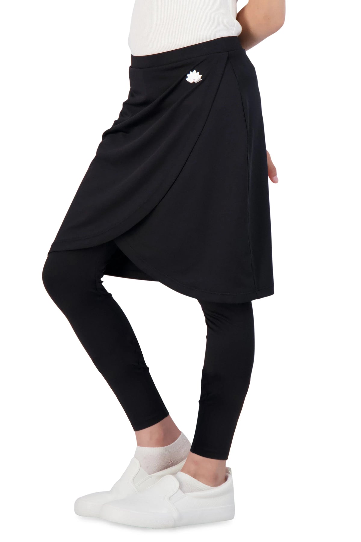 Girl wearing Snoga Athletics black faux wrap skirt with leggings and white sneakers