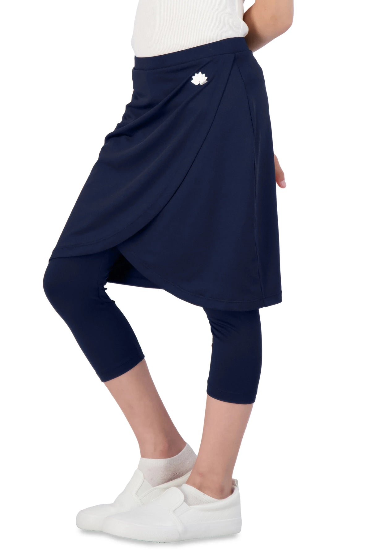 Snoga Athletics girls faux wrap navy skort with attached leggings, side logo, white sneakers