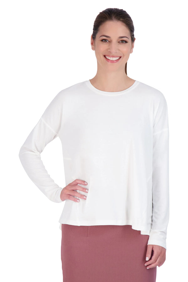 Woman wearing Snoga Athletics white long sleeve tee and mauve skirt, clean background