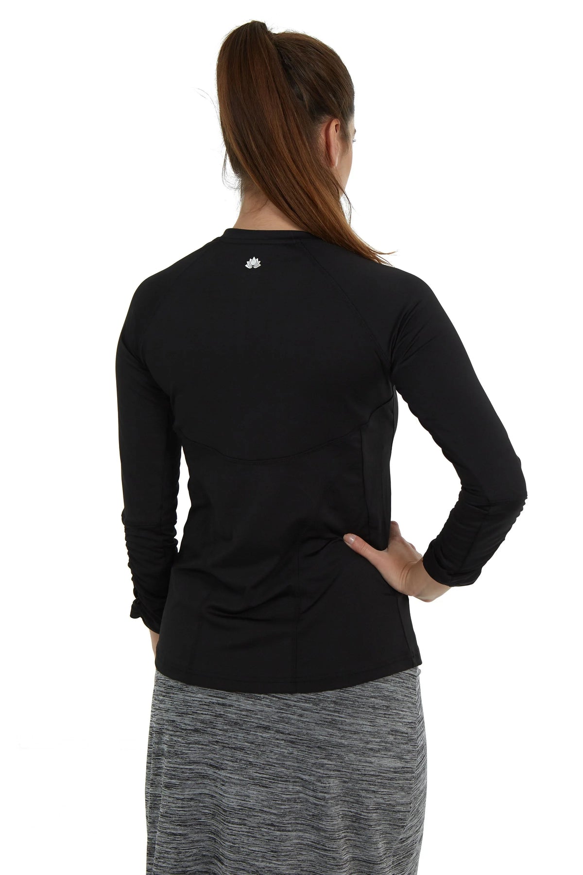 Woman wearing Snoga Athletics black long sleeve modest active top and grey skirt, back view