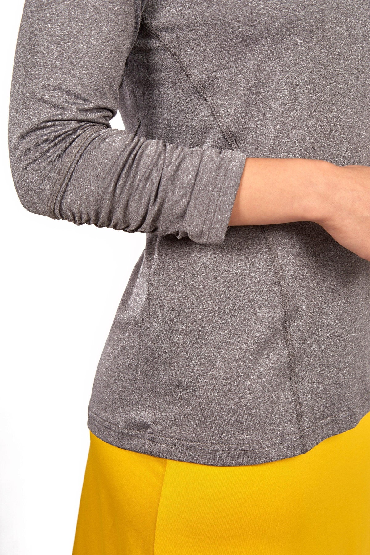 Snoga Athletics heather grey long sleeve active top and yellow skirt, partial view