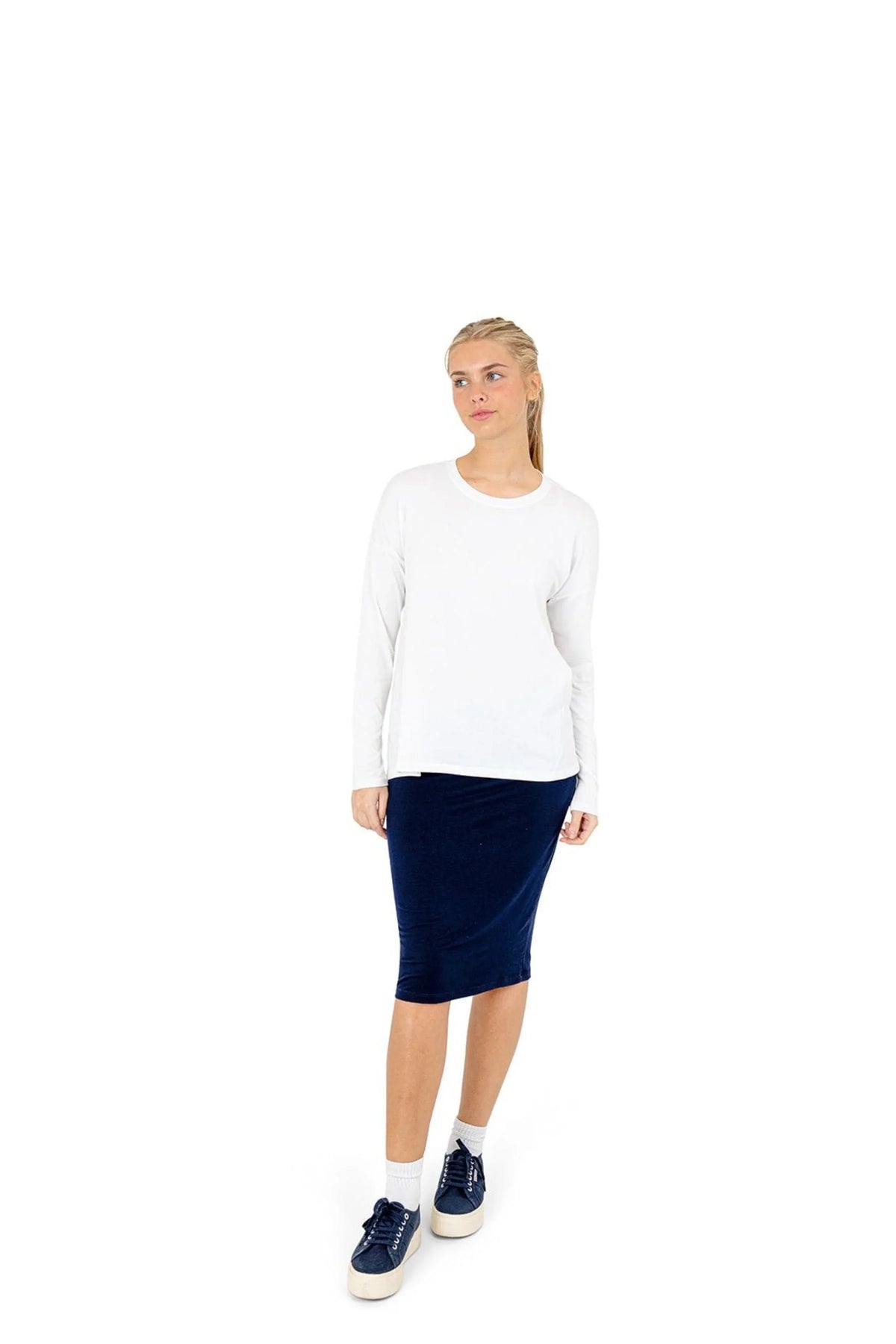 Woman wearing Snoga Athletics navy t-shirt skirt and white long sleeve top