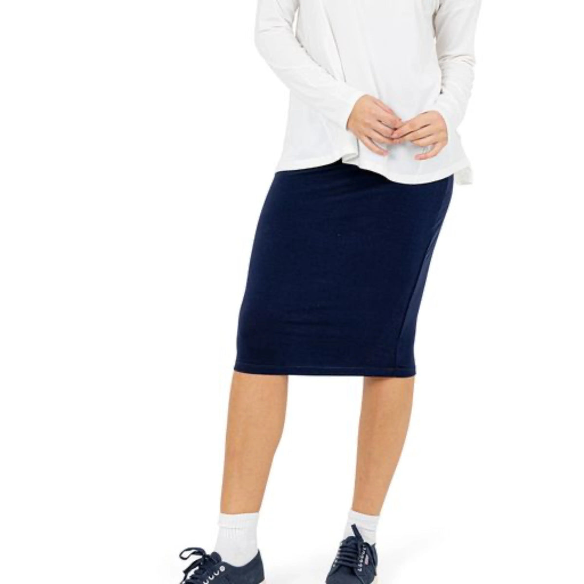 Snoga Athletics navy knee-length athletic skirt with white long sleeve top and sneakers
