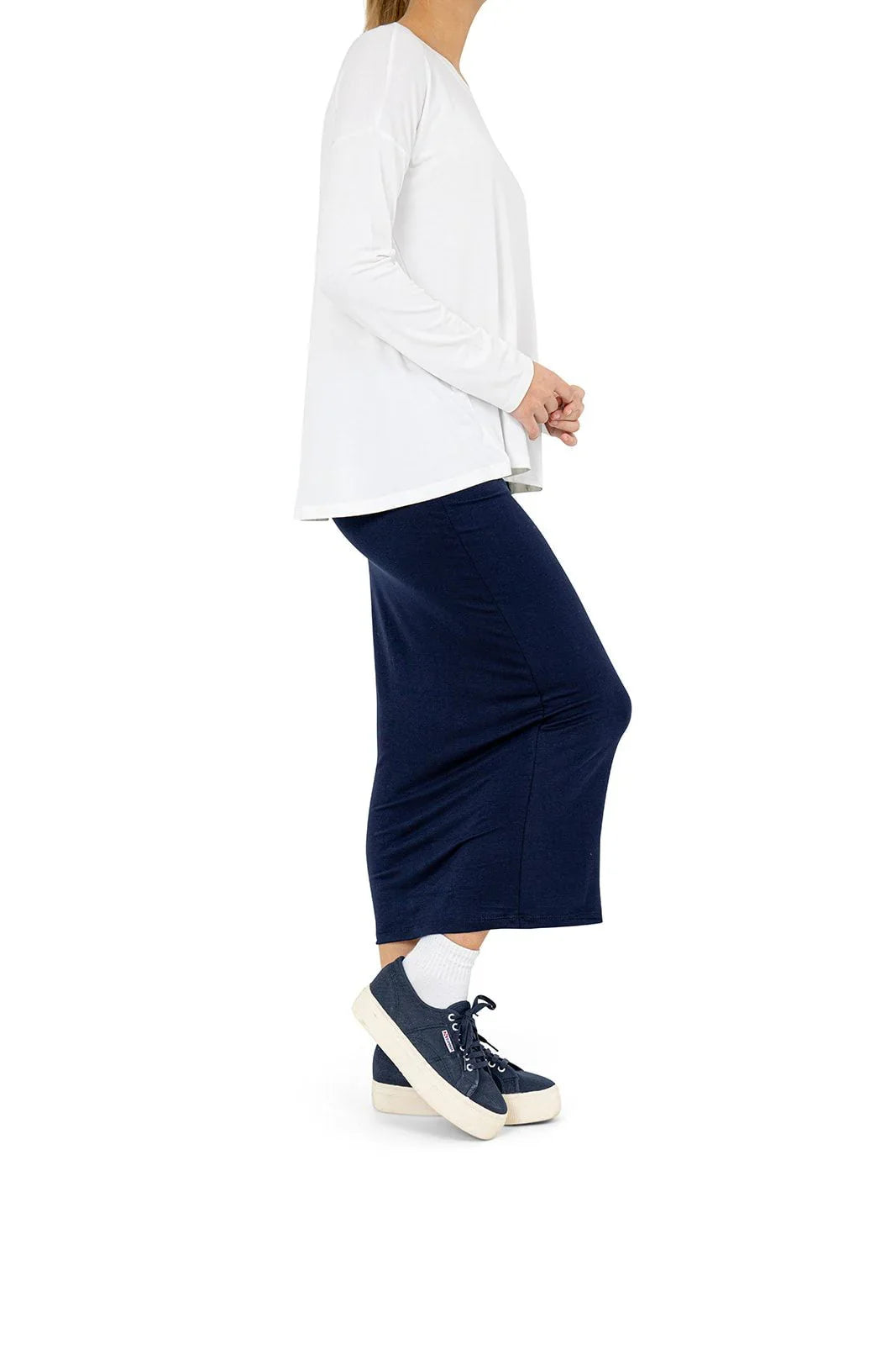 Woman wearing Snoga Athletics navy modest athletic skirt and white long sleeve top