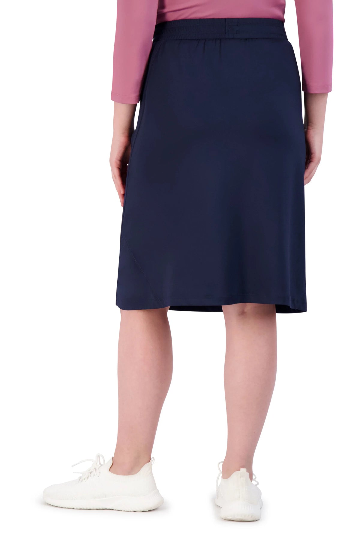 Back view of navy blue athletic skirt by Snoga Athletics, knee-length, worn with sneakers