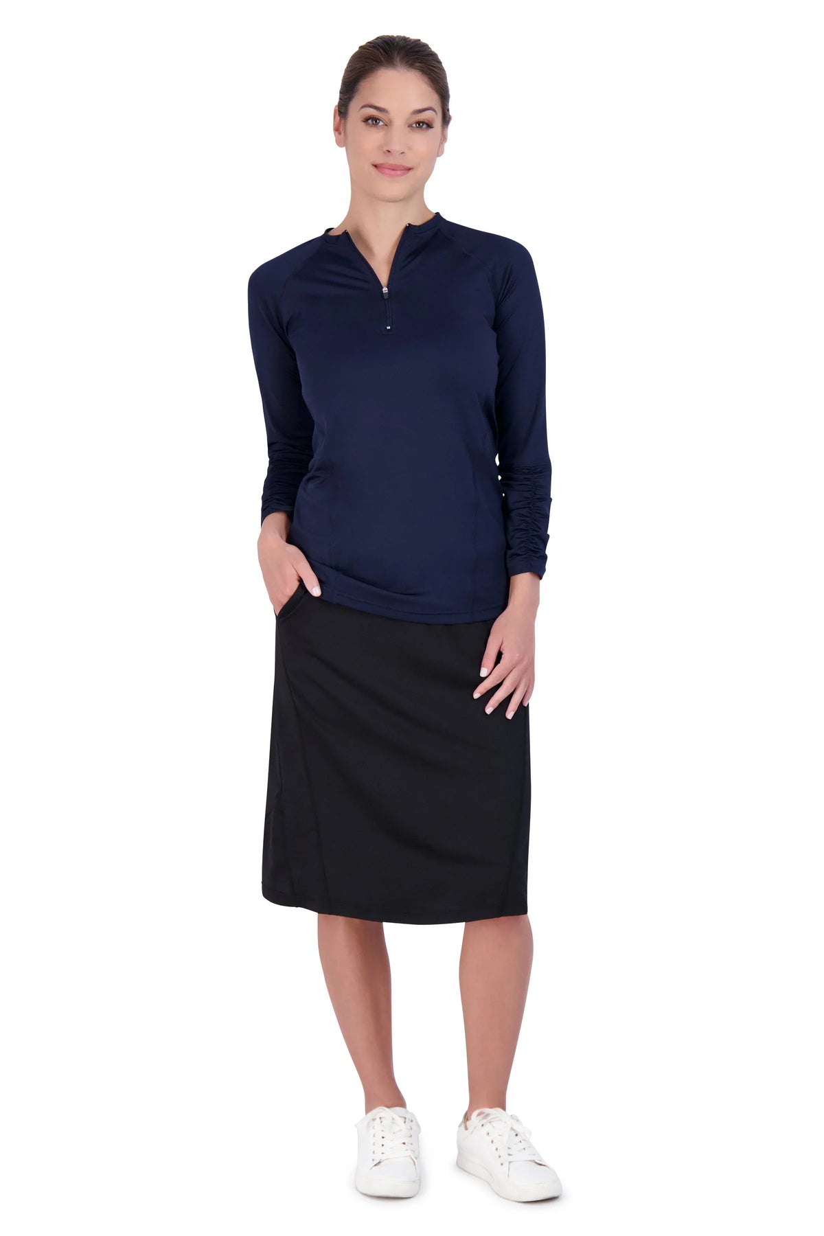 Woman in a modest black Snoga Athletics travel skirt, navy top, and white sneakers