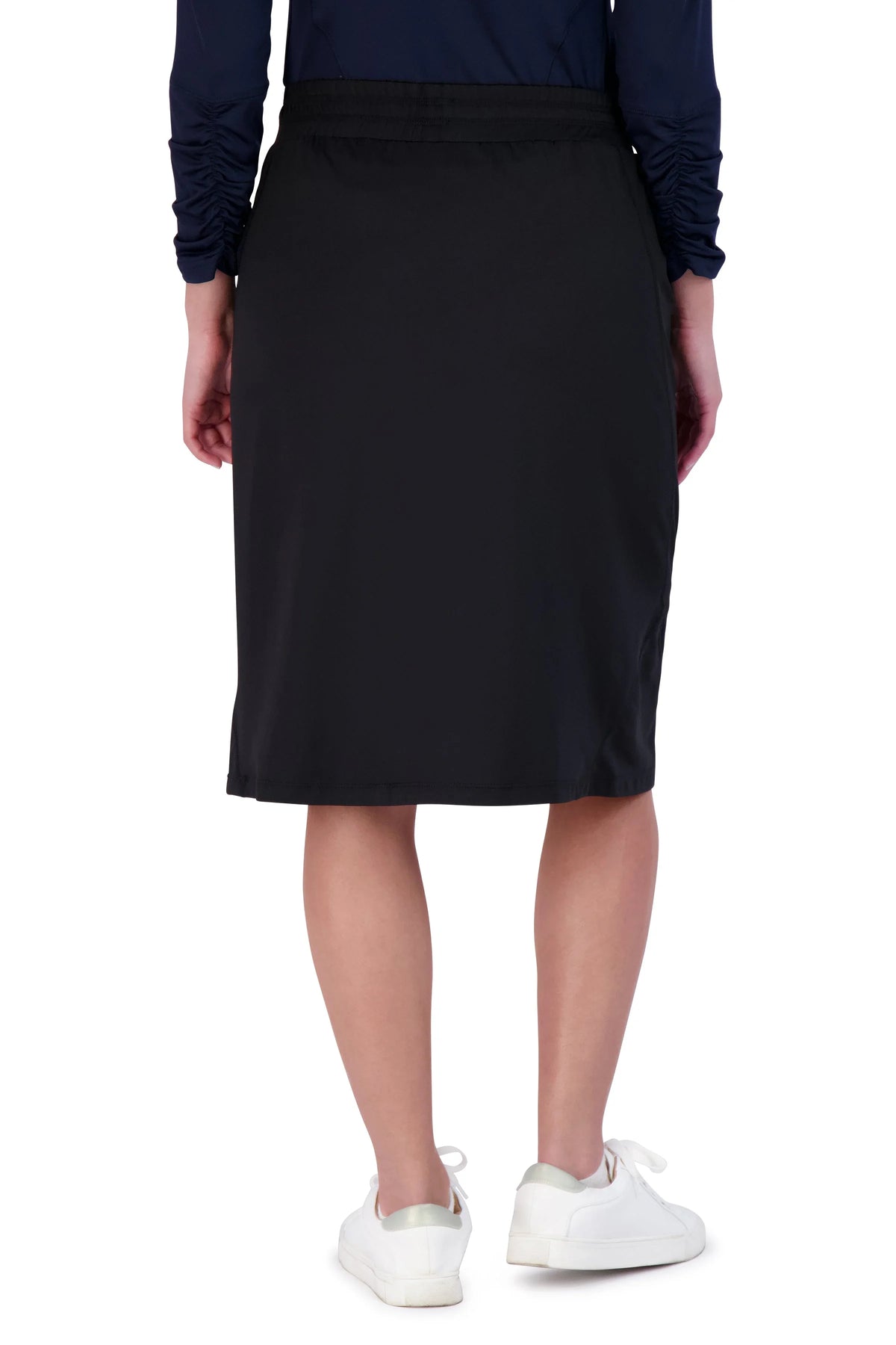 Snoga Athletics black active travel skirt, knee-length, shown from the back on model