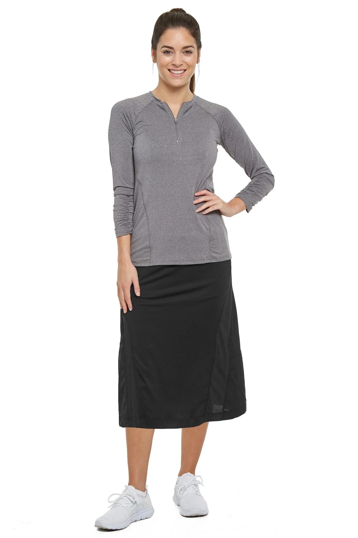 Woman wearing Snoga Athletics black travel skirt with gray long sleeve athletic top