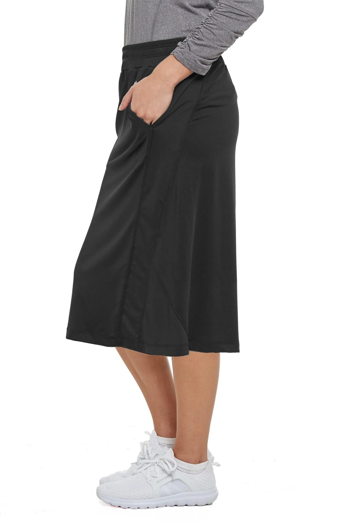 Snoga Athletics black athletic travel skirt with pockets, shown on model in side view