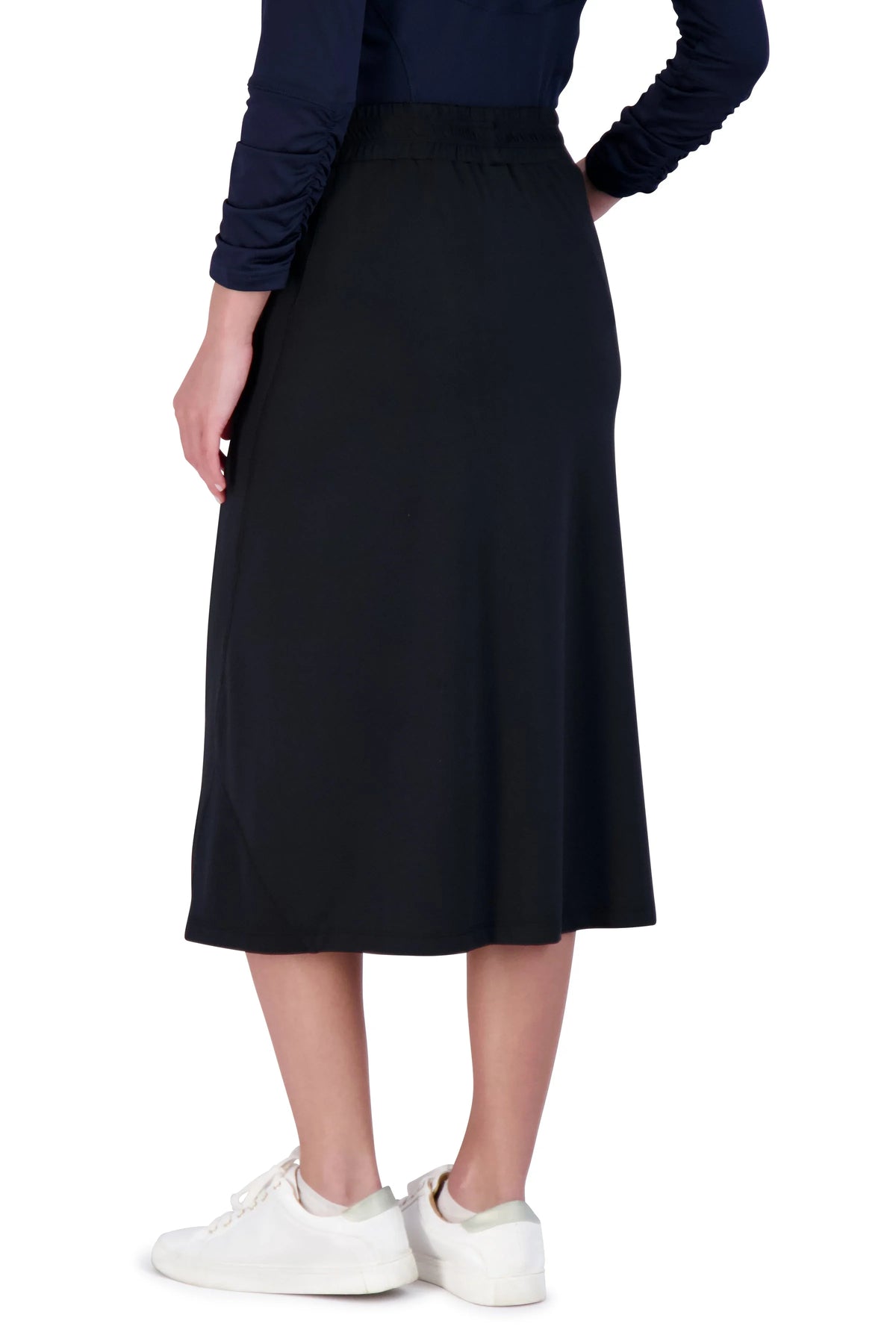 Woman wearing Snoga Athletics black athletic travel skirt with white sneakers