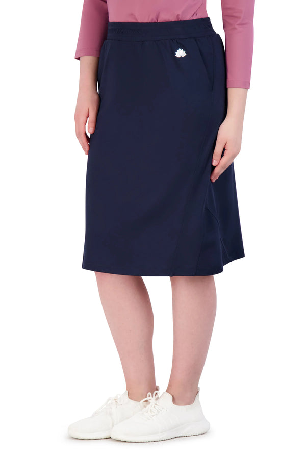 Woman wearing navy blue knee-length athletic skirt by Snoga Athletics
