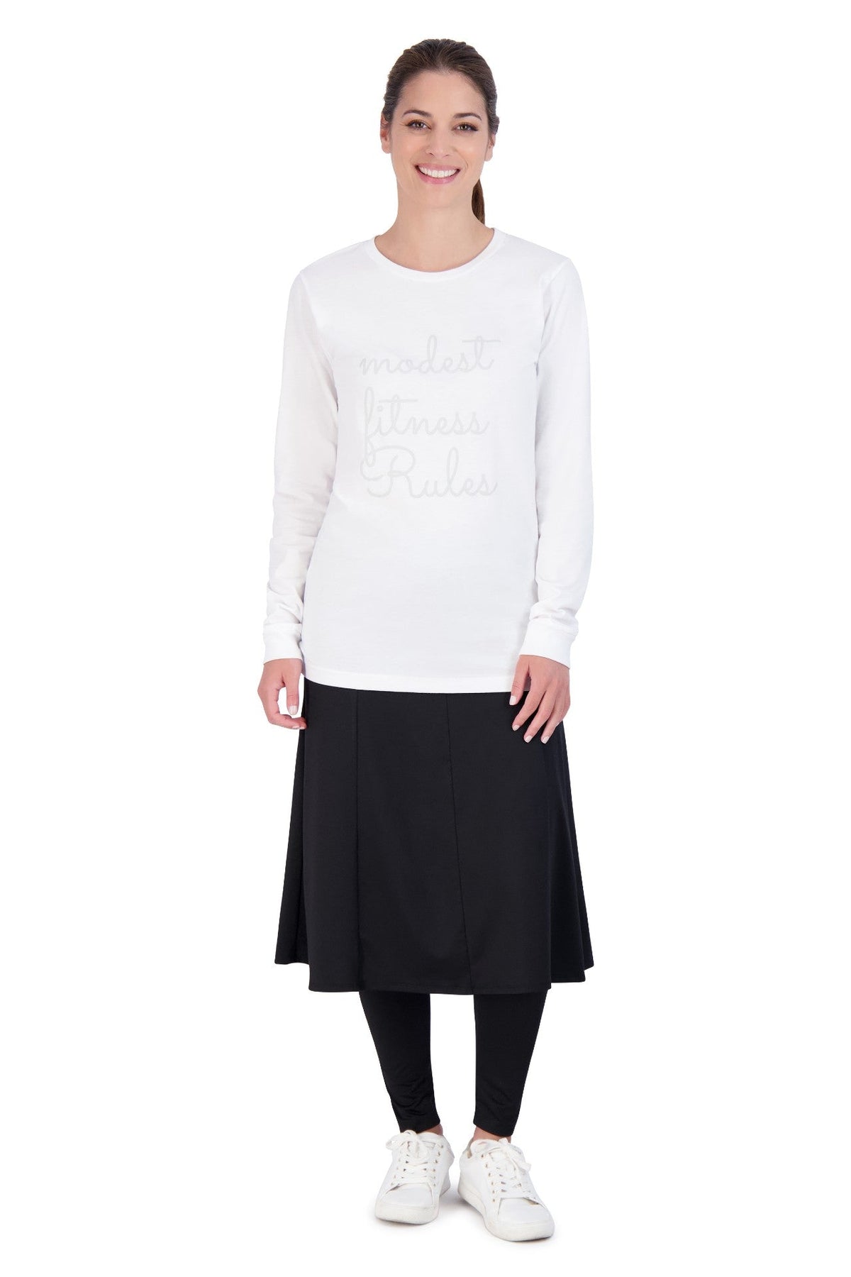 Woman modeling Snoga Athletics black ankle ballet skirt with attached leggings and white top