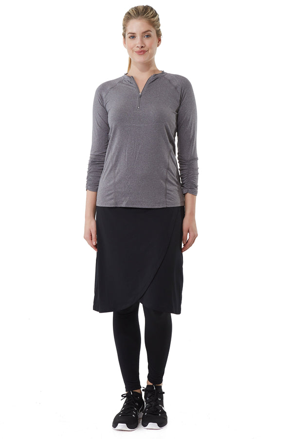 Woman modeling Snoga Athletics black ankle faux wrap skirt with leggings and grey zip top