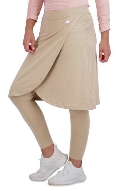 Woman wearing Snoga Athletics ankle faux wrap skirt with attached leggings in beige