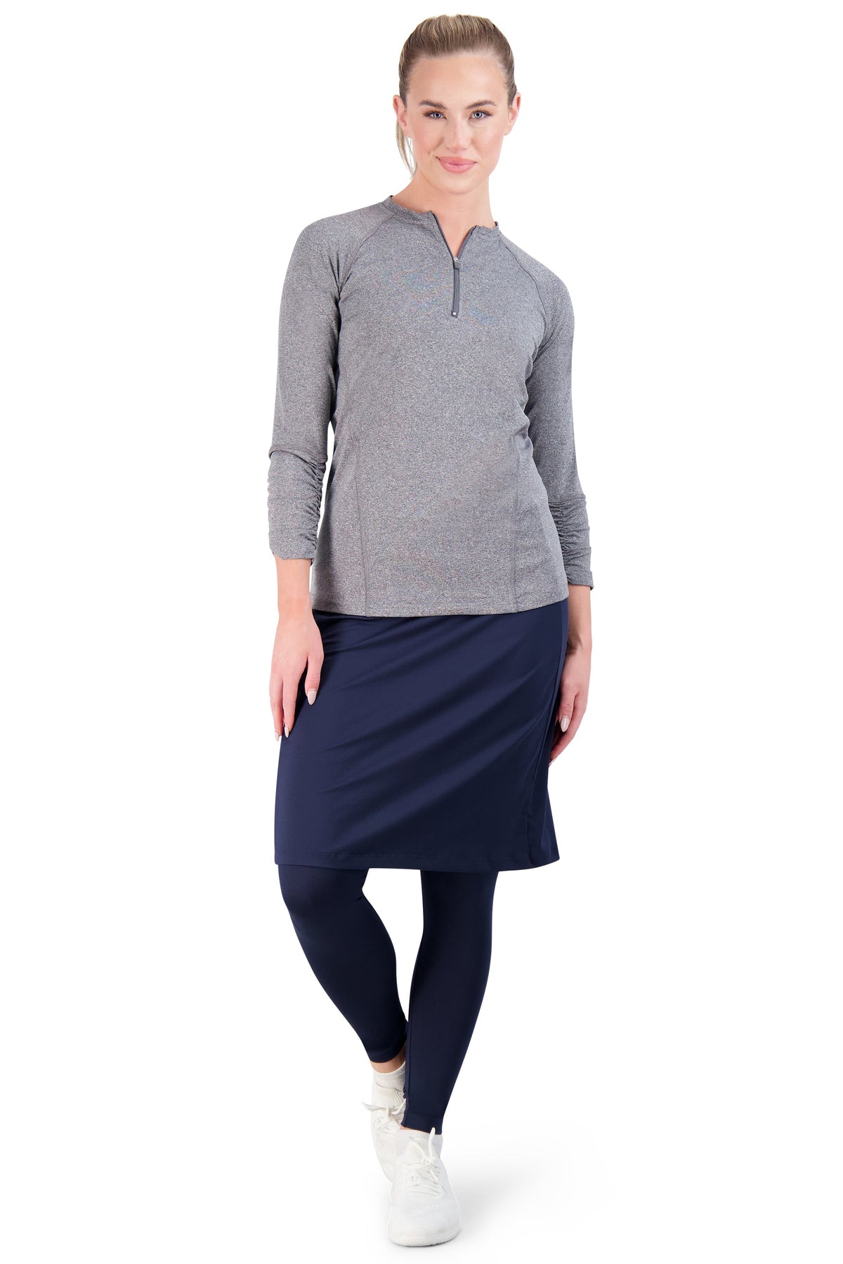 Woman in Snoga Athletics navy ankle-fit skirted leggings and gray athletic top