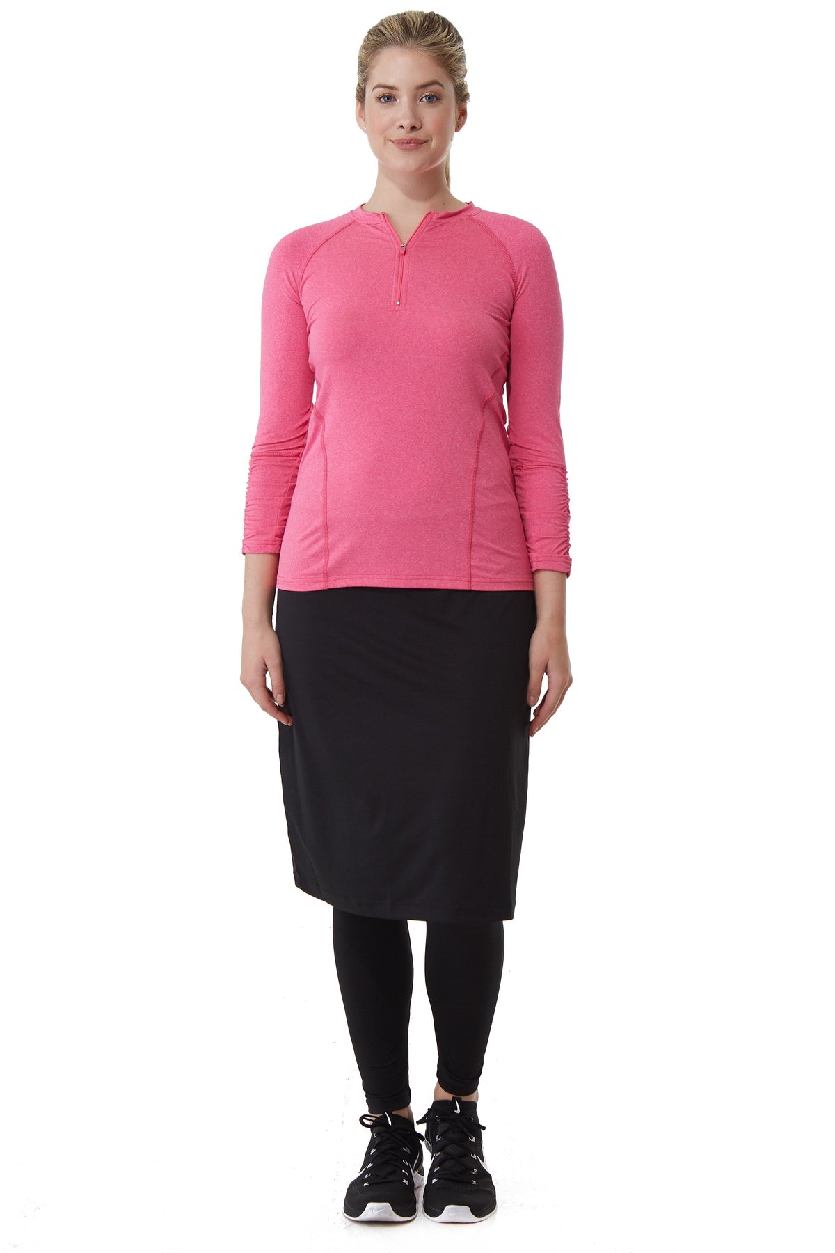 Snoga Athletics black ankle midi skirt with attached leggings, worn with pink long sleeve top
