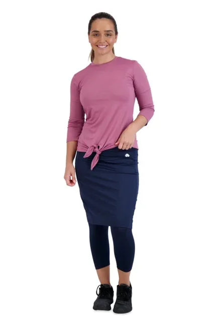 Woman wearing Snoga Athletics navy skirted leggings and pink top, modest activewear