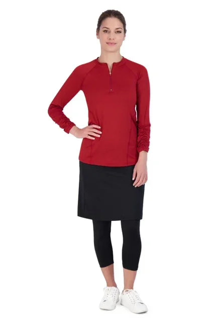 Woman wearing Snoga Athletics black modest skirt with leggings and a red long sleeve top