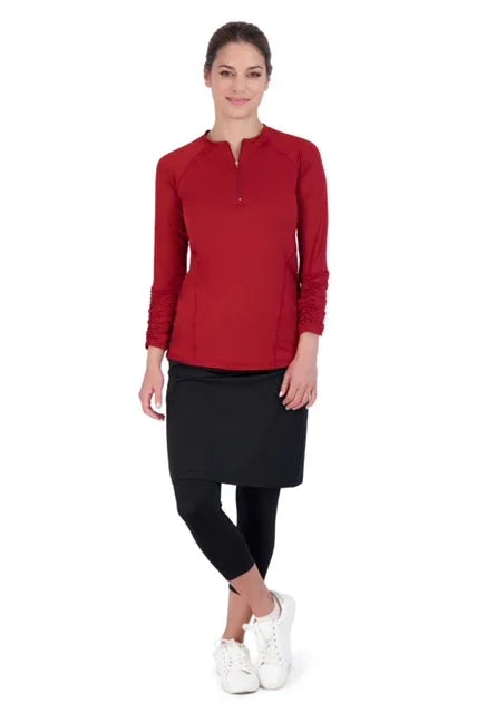 Woman wearing Snoga Athletics black modest skirt leggings with red long sleeve top