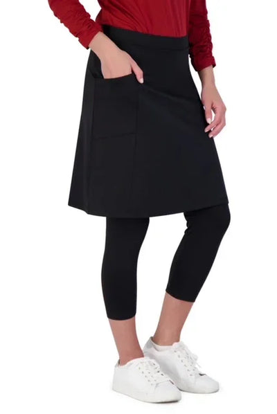 Woman wearing Snoga Athletics black modest skirt with attached leggings and white sneakers