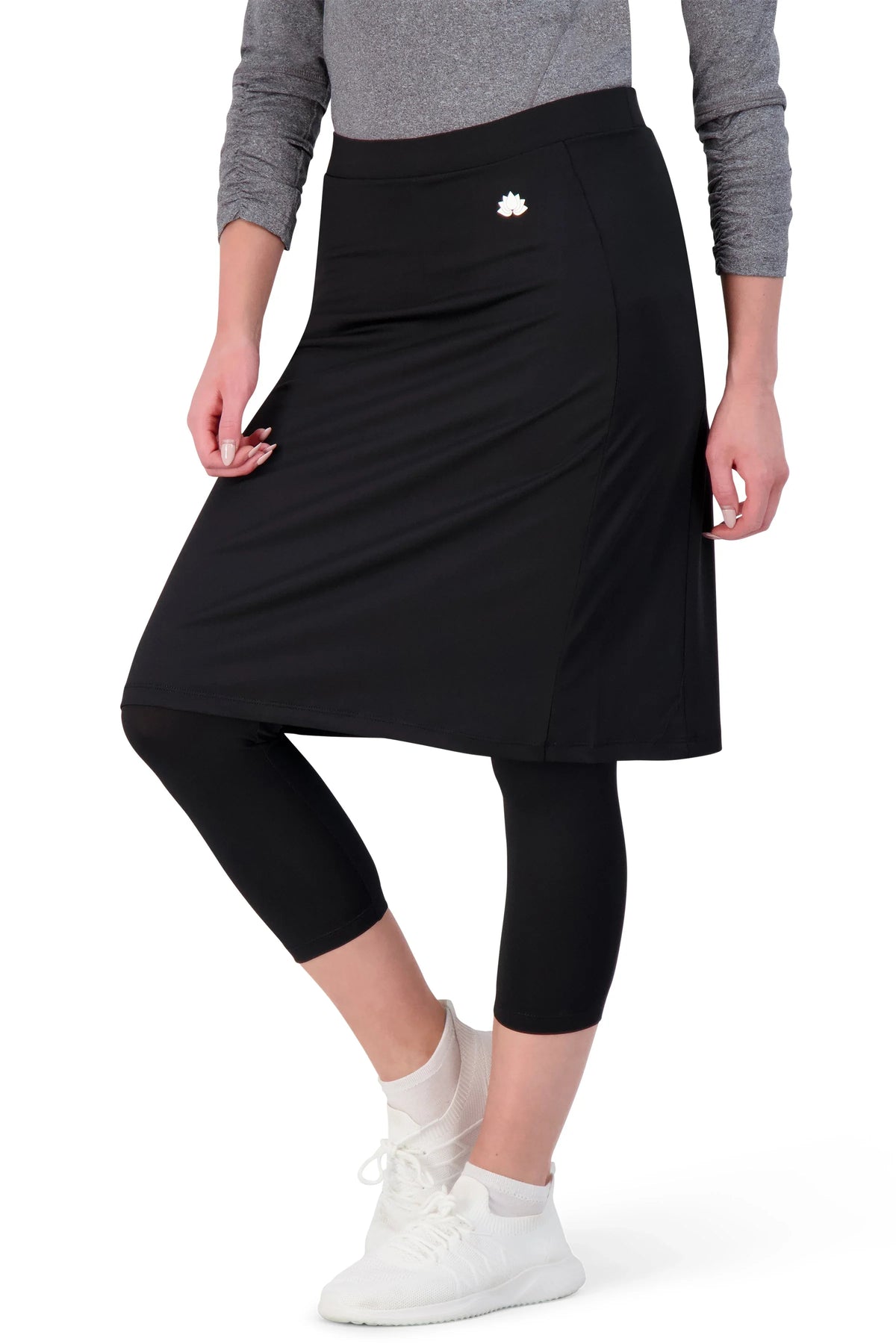 Snoga Athletics black skirted leggings with logo, modeled with gray top and white sneakers