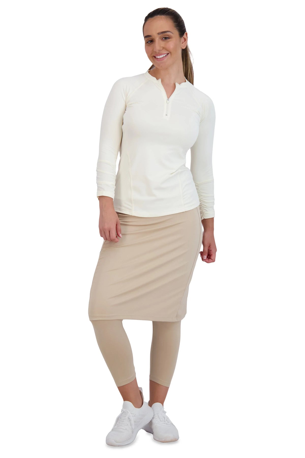 Woman wearing Snoga Athletics modest activewear set with beige skirted leggings and white top
