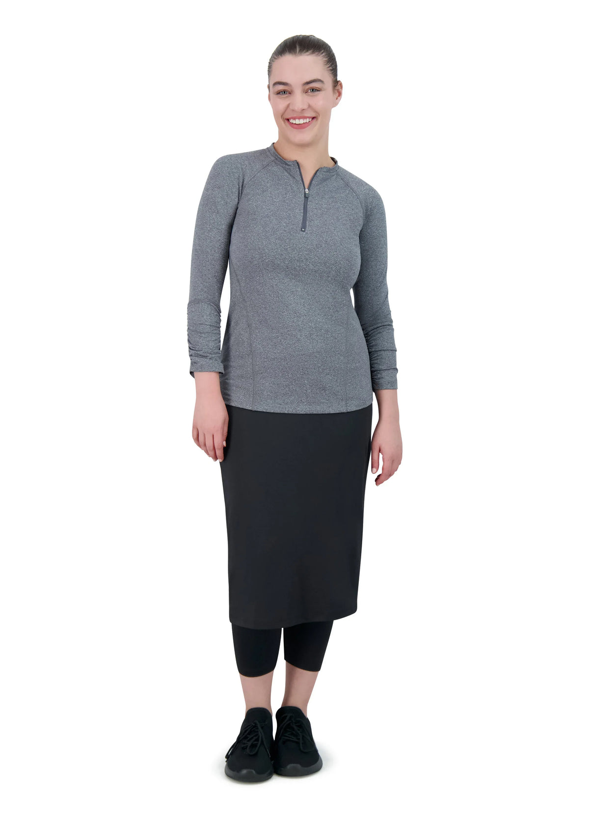 Woman wearing Snoga Athletics modest black skirt leggings and gray long-sleeve top