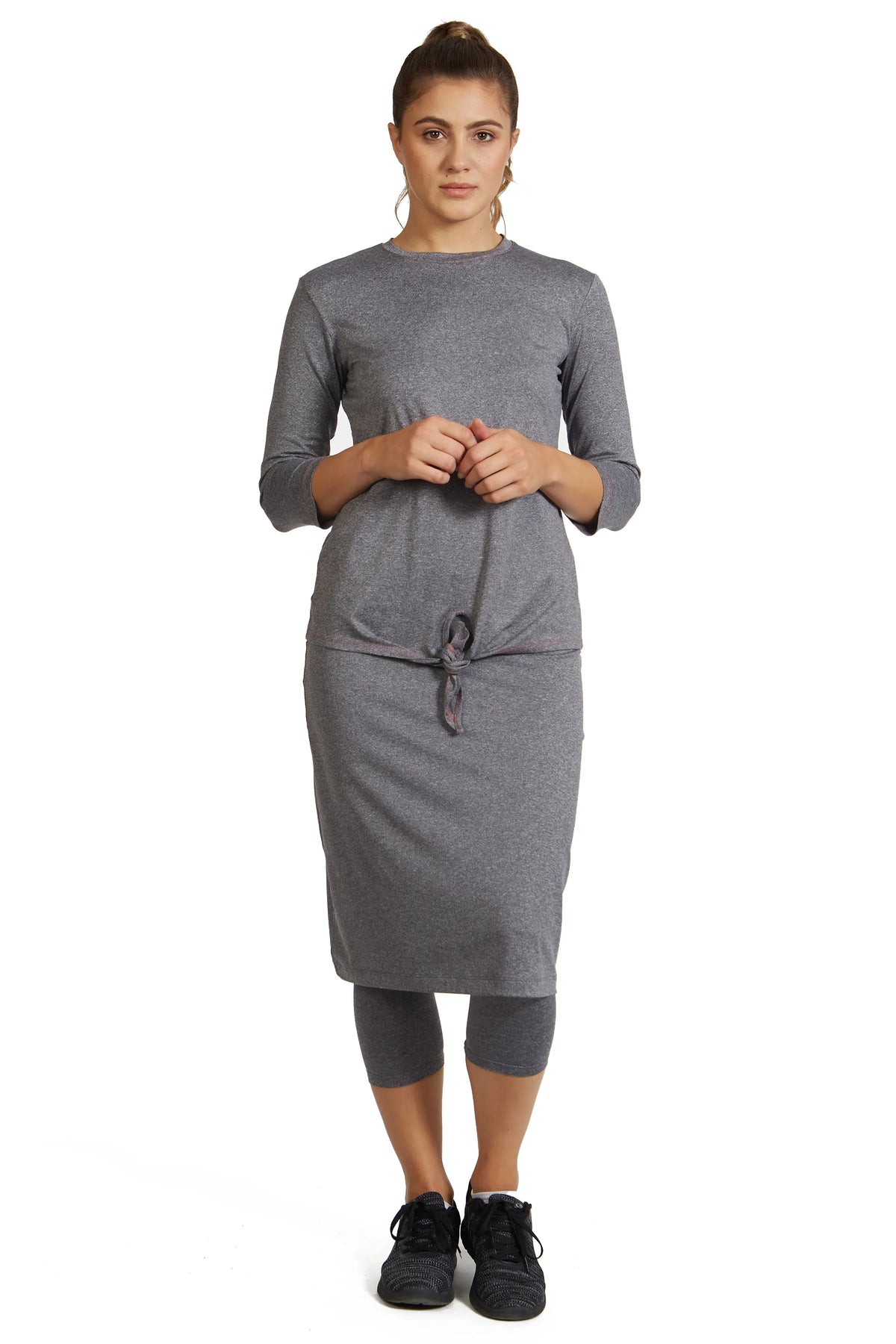 Woman wearing Snoga Athletics heather grey modest midi skirt leggings with tie waist