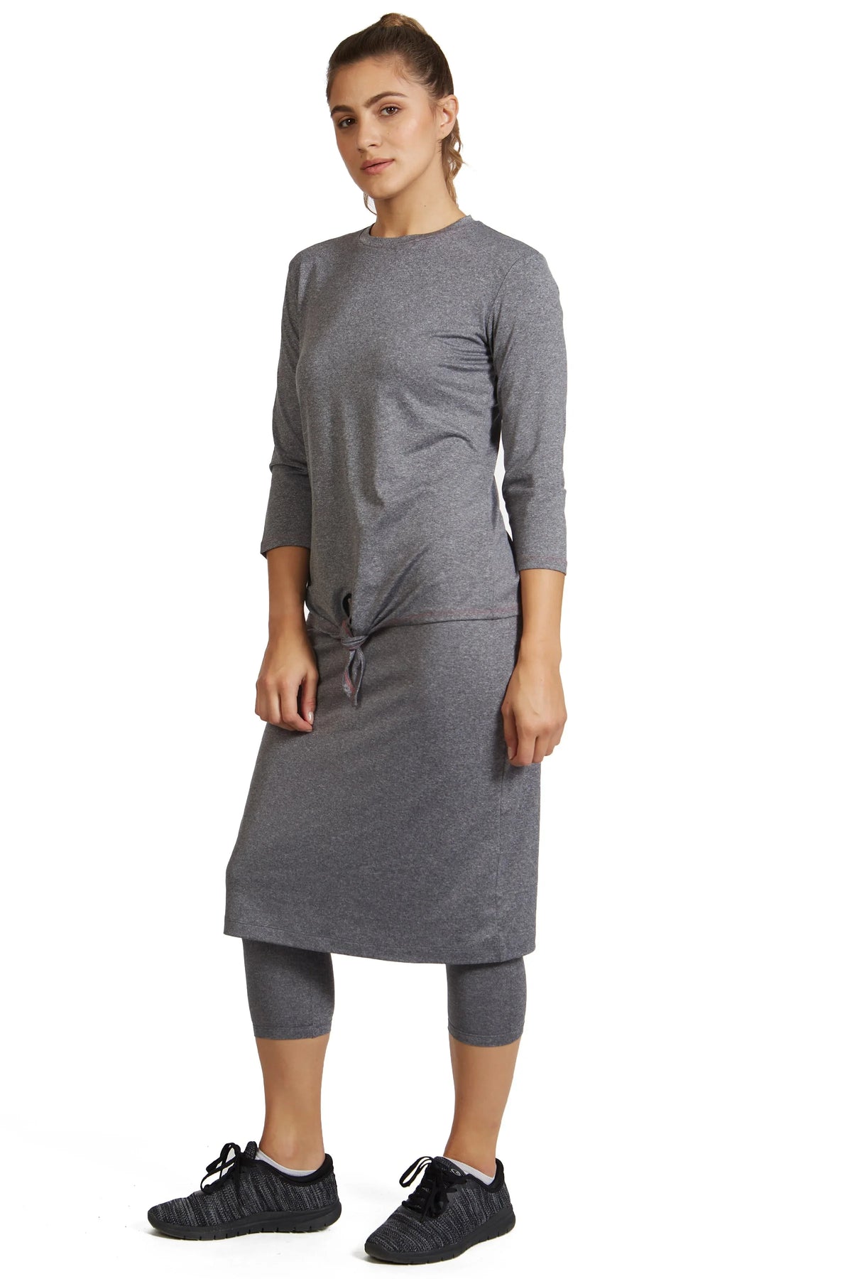 Woman wearing Snoga Athletics heather grey modest activewear skirt with attached leggings