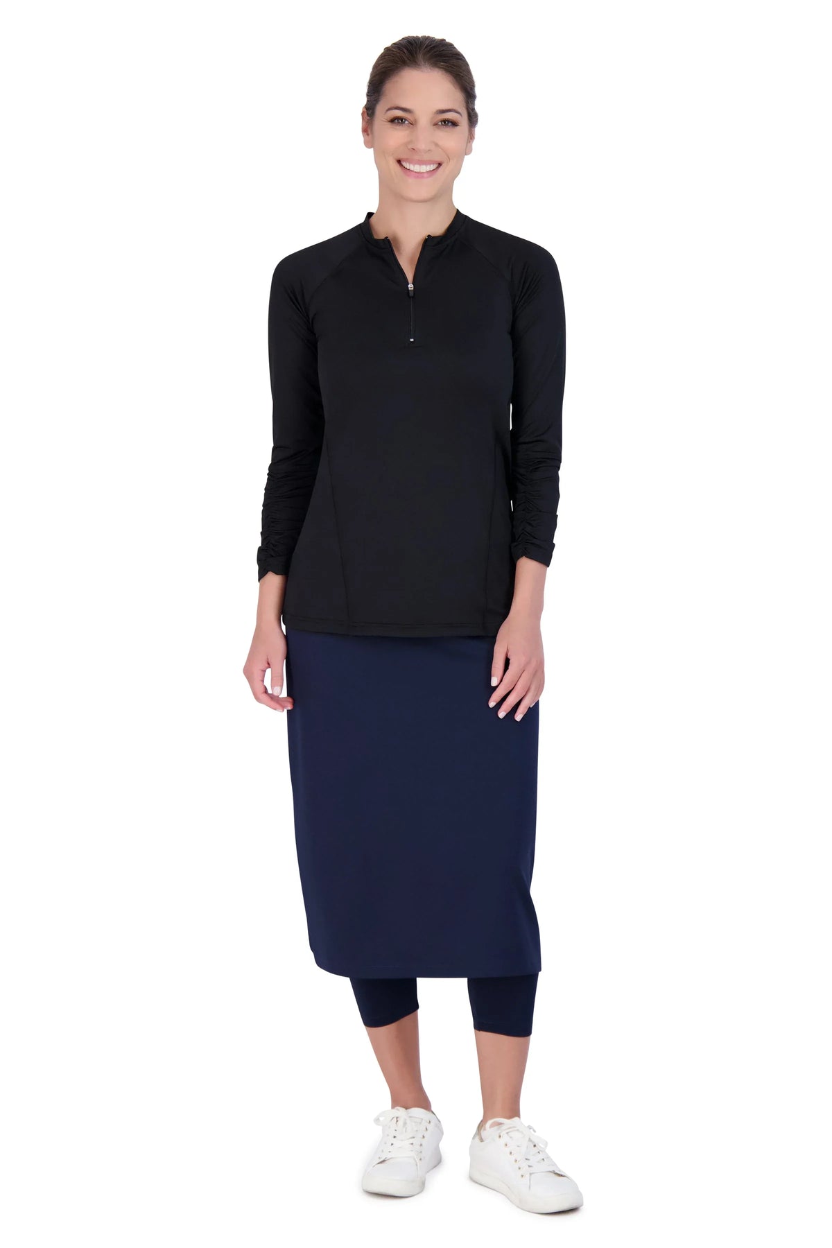 Woman wearing Snoga Athletics navy midi skirt with leggings and a black long-sleeve top