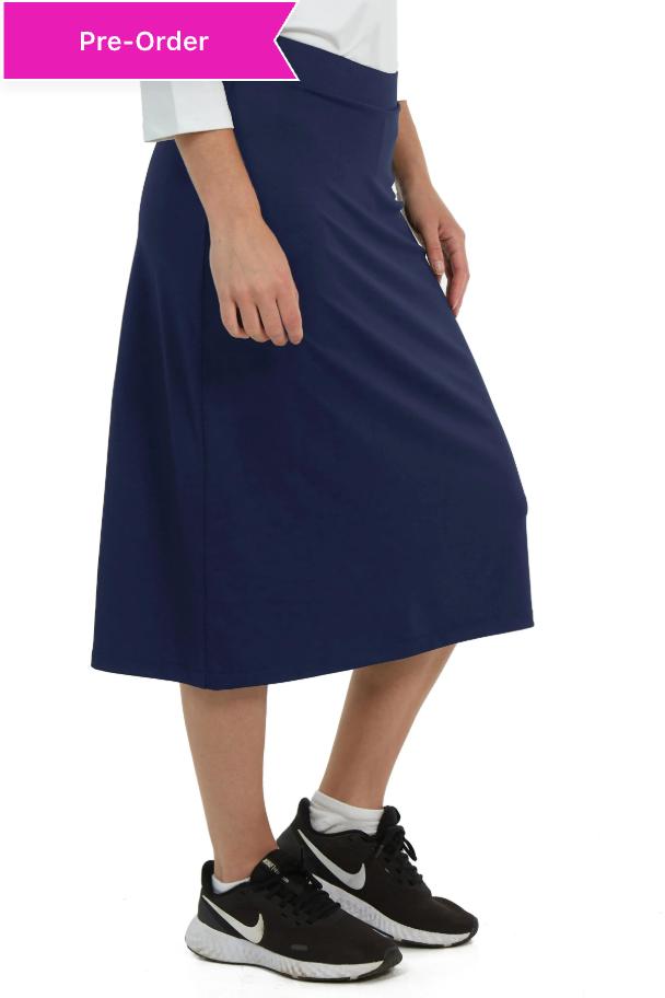 Snoga Athletics navy midi sports skirt with attached shorts, worn by a woman